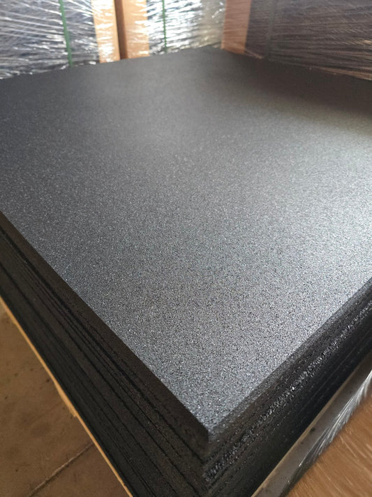Stack of black rubber flooring tiles