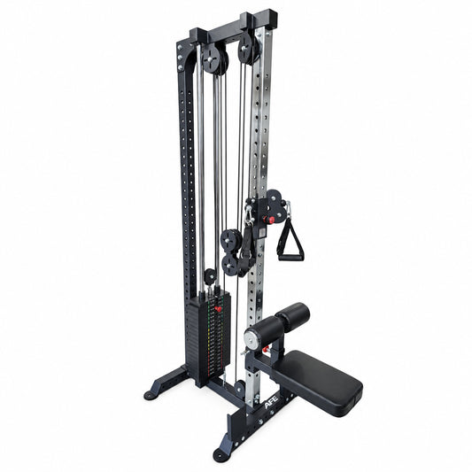 A dual-stack cable pulley gym machine with a leg extension attachment, featuring a dark gray and silver steel frame with black padded components, isolated on a white background.