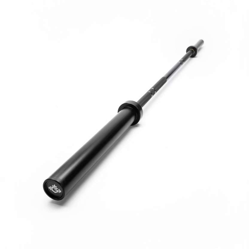 A black metal barbell resting diagonally on a gray wood-look laminate floor. The bar has a white printed logo on one end and a black weight plate on the other.