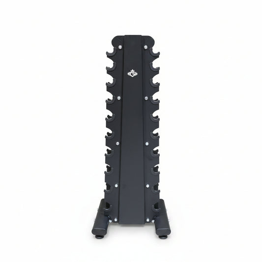 A black metal upright rack with multiple peg slots, standing on a concrete warehouse floor with shelves and stacked cardboard boxes in the background.