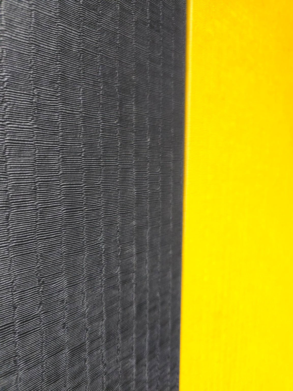 Close-up of textured black and yellow surface