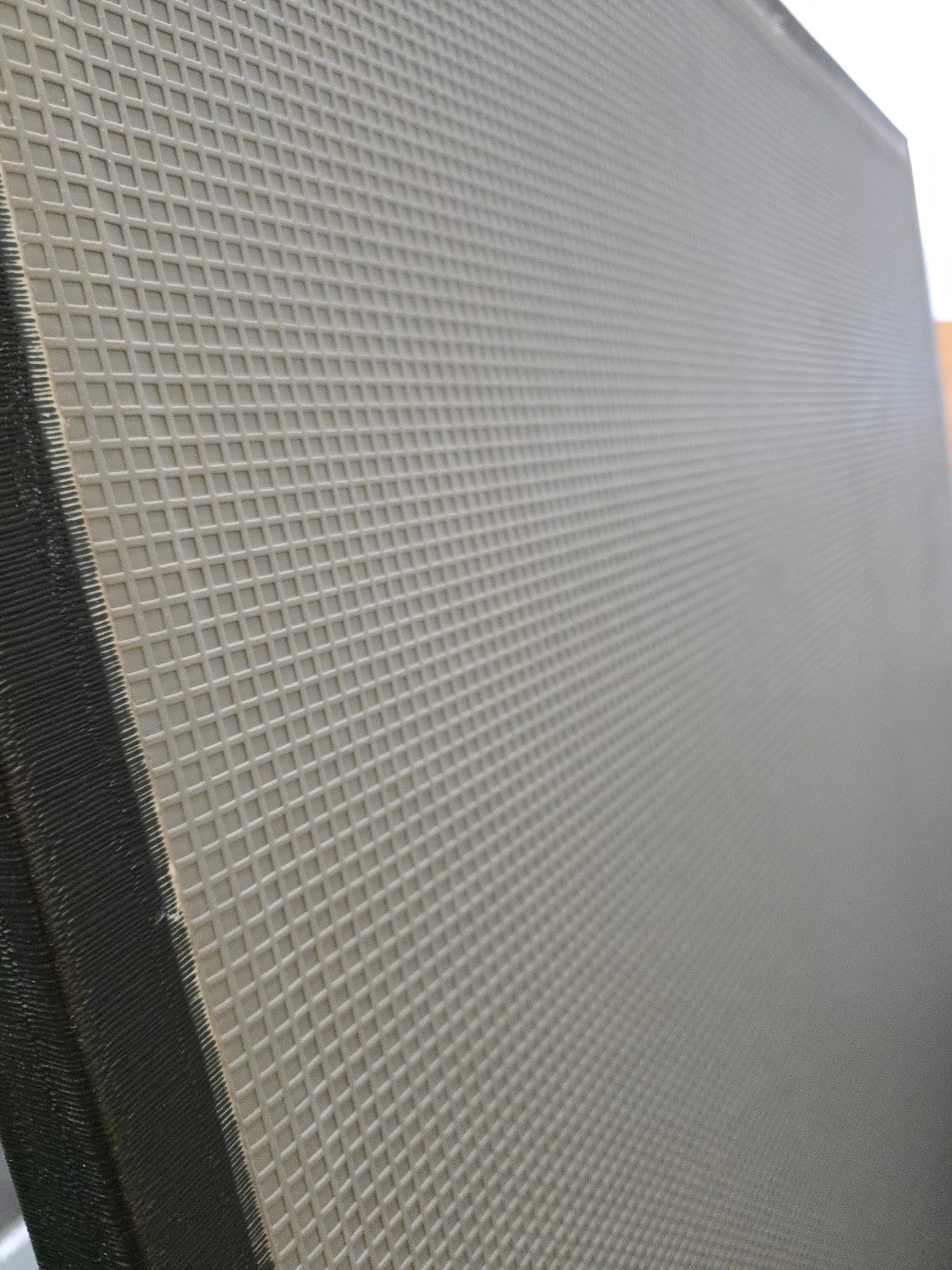 Textured gray panel with a grid pattern non slip bottom