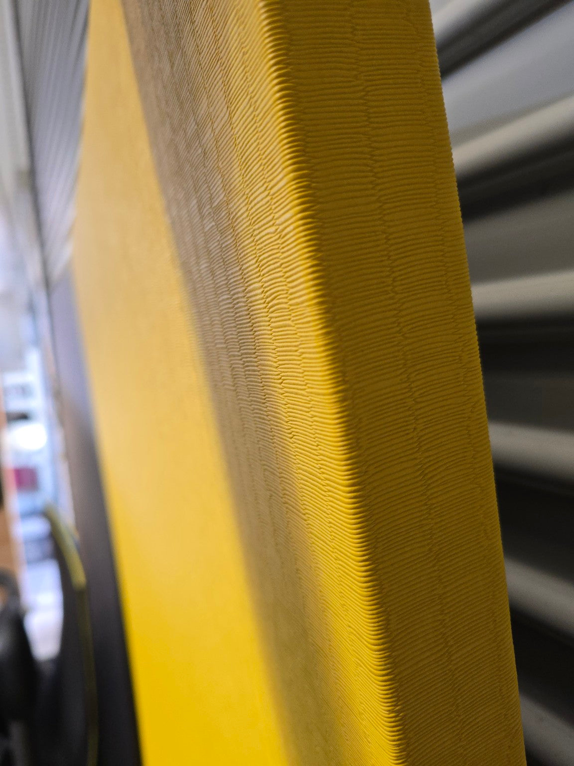 Close-up of a textured yellow surface with a blurred background