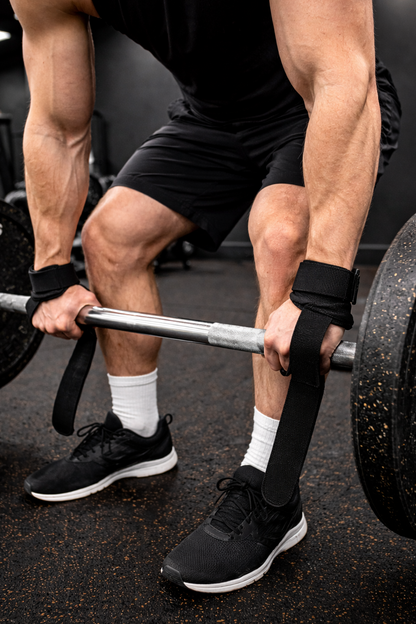 Person lifting a barbell in a gym setting