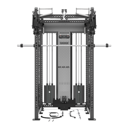 A large black and gray cable pulley gym machine with a barbell resting horizontally across the top, shown on a plain white background. Small accessory pieces are placed on the floor in front.