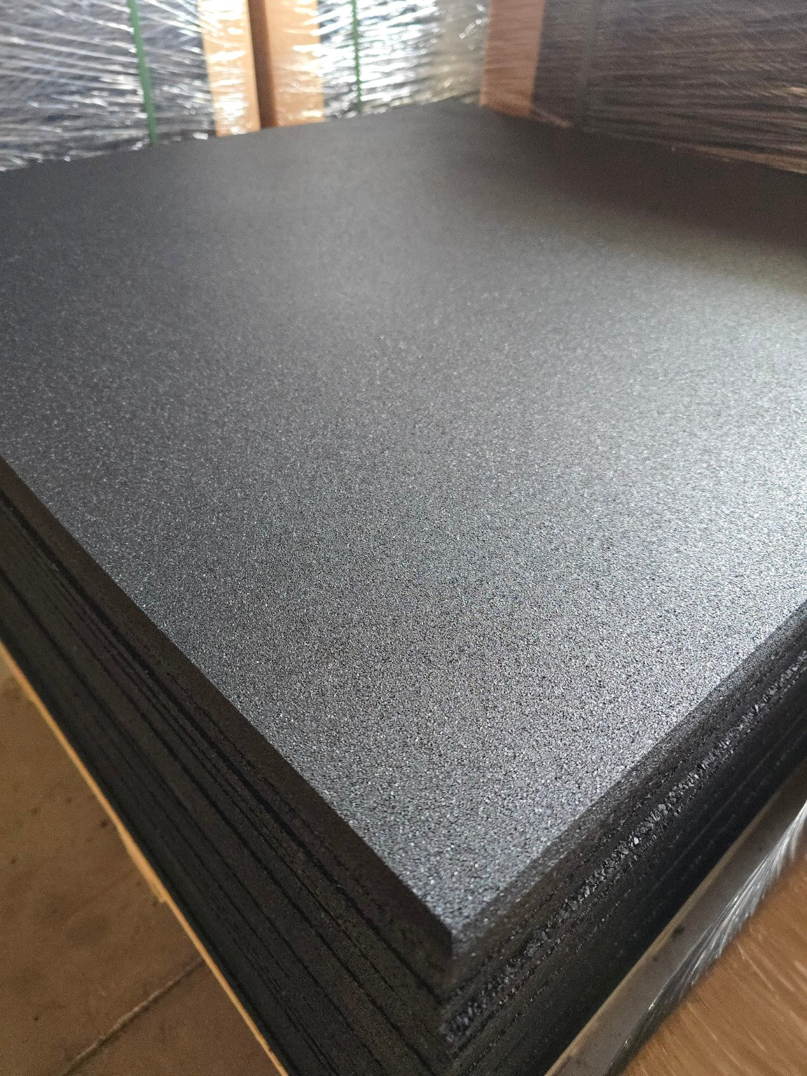 Stack of black rubber flooring tiles