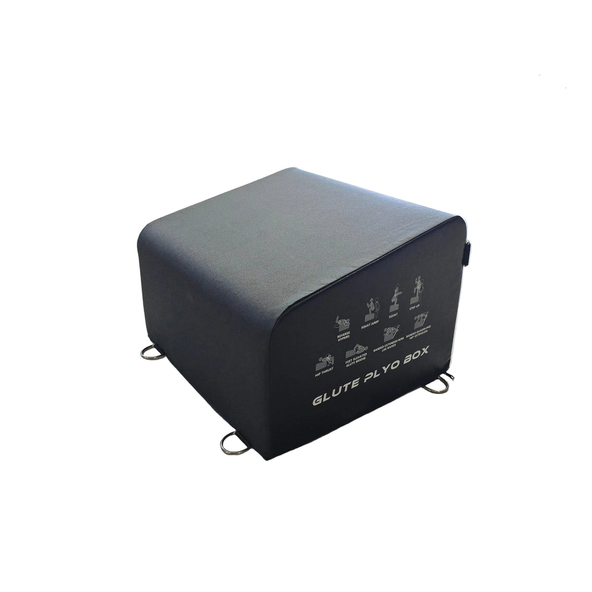 A black GLUTE PLQ BOX fitness accessory with printed exercise diagrams on the front, placed on a light wood floor inside a gym.