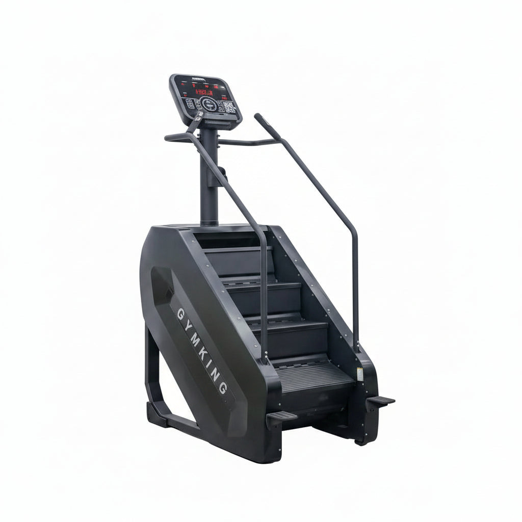 A black stair climber exercise machine with a digital display screen and handrails, positioned against a plain light gray wall and concrete floor.