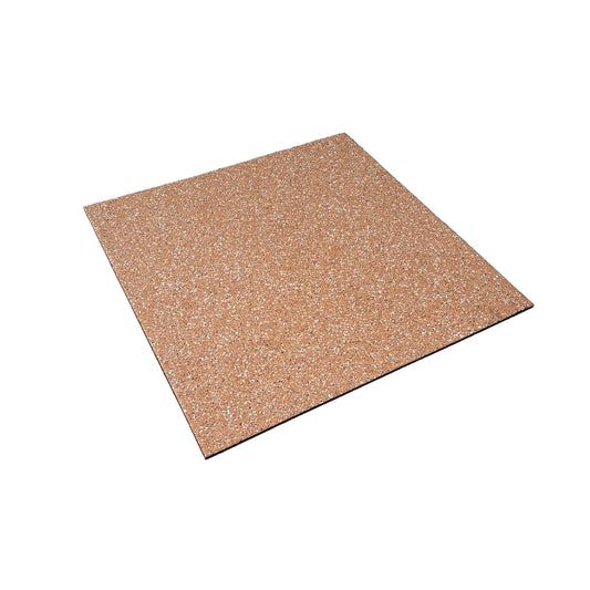 A square terrazzo-style floor tile with a warm orange-brown base and white speckles, shown on a concrete floor in what appears to be a warehouse or workshop.