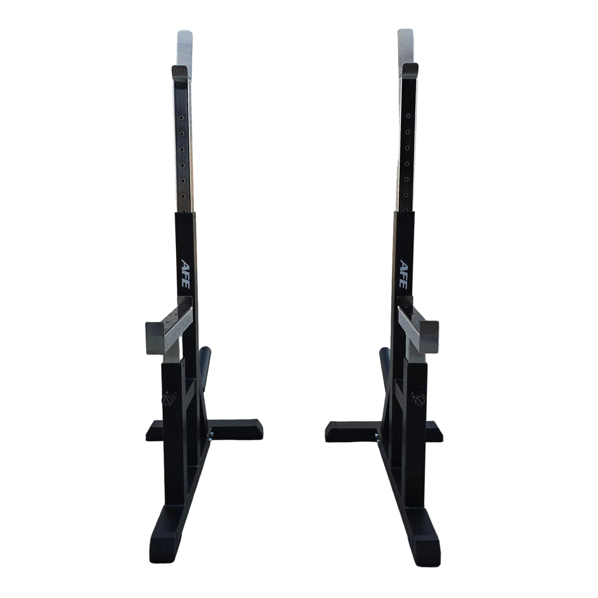 Two black AFE power racks with silver safety rails, positioned side-by-side on a concrete floor in front of a white garage door.