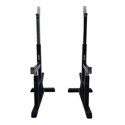 Two black AFE power racks with silver safety rails, positioned side-by-side on a concrete floor in front of a white garage door.