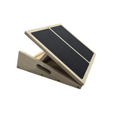 Adjustable wooden slant board at a mid incline showing box base and carry handle