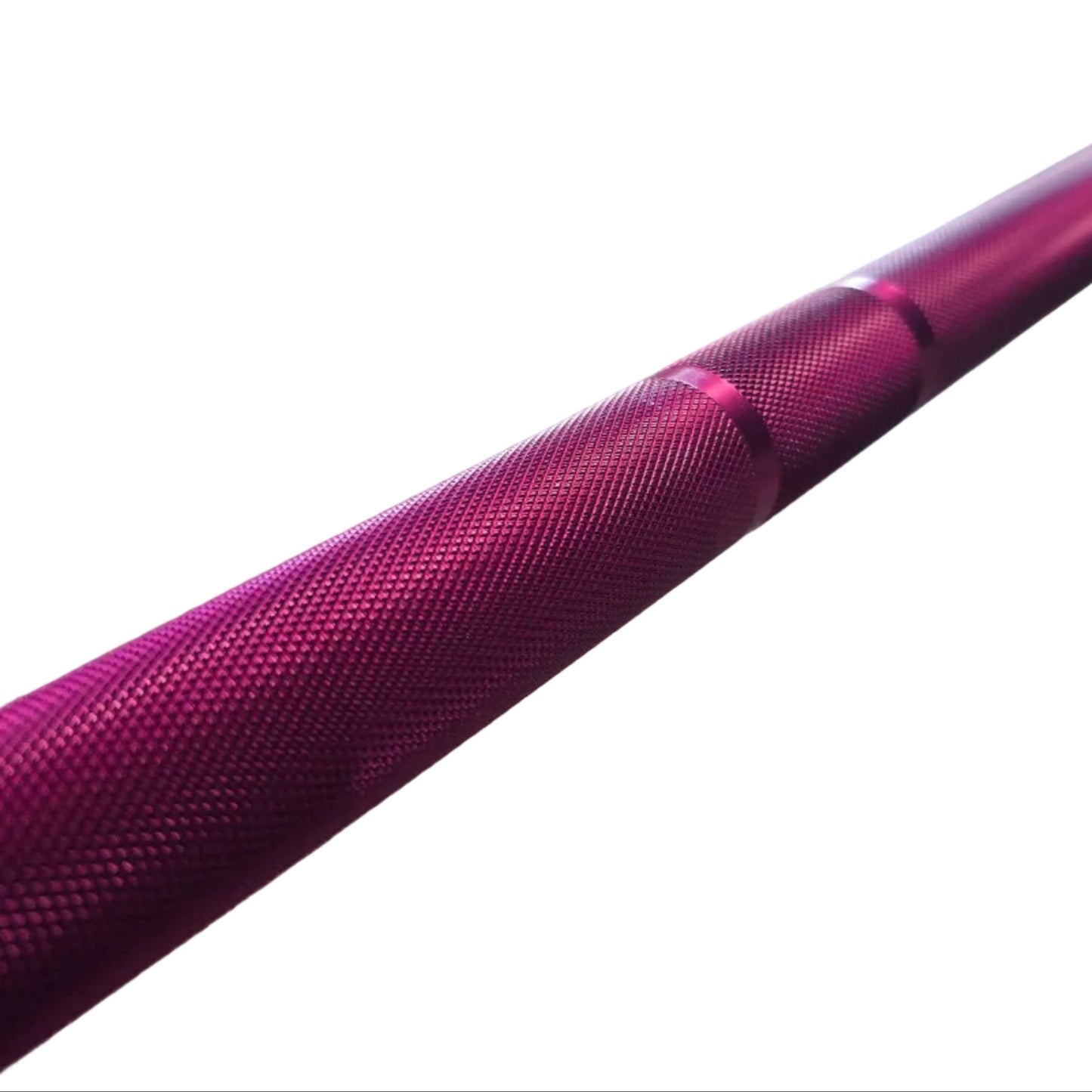 A close-up of a metallic magenta barbell rod resting on a gray wood-look floor inside a gym.