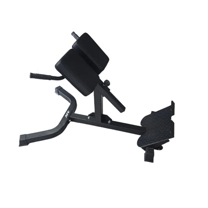 A black adjustable weight bench with a footrest and padded backrest, photographed in a gym with gray wood-look flooring and other exercise equipment in the background.