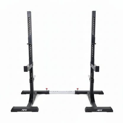 A black AFE power rack with a white fabric backdrop hanging between the uprights, set in a gym with wood-look flooring and exercise equipment in the background.